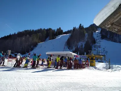 a group of people on skis on a ski lift at Apartment Jakelj in Kranjska Gora