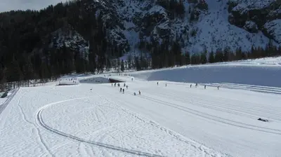 a group of people skiing down a snow covered slope at Apartment Jakelj in Kranjska Gora