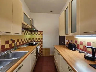 a kitchen with a sink and a counter top at Historic Townhouse Apartment Tina by City Hall in Ljubljana