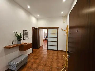 a room with a hallway with a door and a bench at Historic Townhouse Apartment Tina by City Hall in Ljubljana