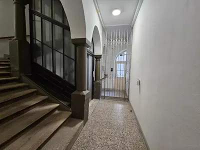 an empty hallway of a building with a gate at Historic Townhouse Apartment Tina by City Hall in Ljubljana