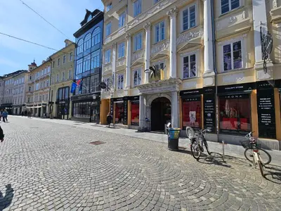 a cobblestone street in a city with buildings at Historic Townhouse Apartment Tina by City Hall in Ljubljana