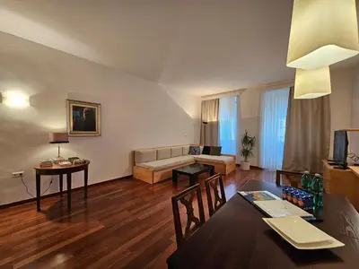 a living room with a table and a couch at Historic Townhouse Apartment Tina by City Hall in Ljubljana