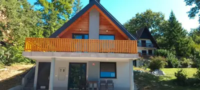 a house with a gambrel roof at Apartma Jezero in Grahovo