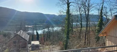 a view of a lake from a house with a rainbow at Apartma Jezero in Grahovo