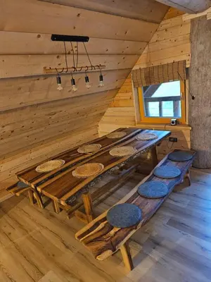 a large wooden table in a room with a wall at Cozy house Dalija in Radovljica