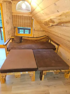 a room with two benches in a log cabin at Cozy house Dalija in Radovljica