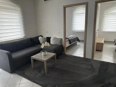 a living room with a couch and a table at Apartments Klavdija Celje in Celje