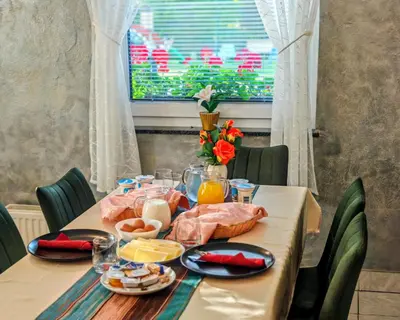 a table with food on it with a window at Gostilna The RIVER in Dravograd