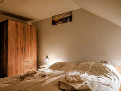 a bedroom with a bed and a wooden cabinet at Gostilna The RIVER in Dravograd