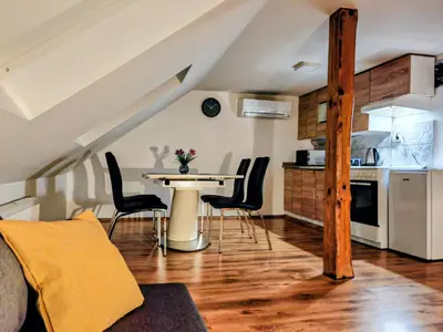 a kitchen and dining room with a table and chairs at Gostilna The RIVER in Dravograd
