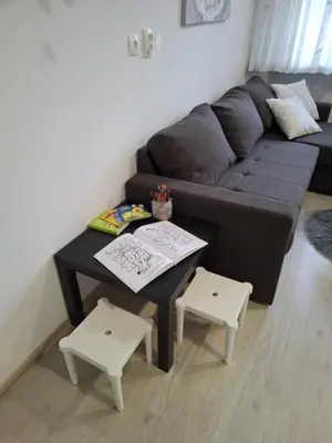 a living room with a couch and a table and two stools at Prenočišča Dany APARTMA 2 in Dravograd