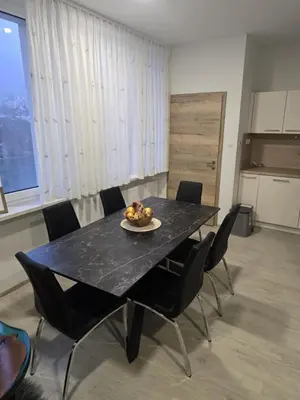 a black table with chairs and a plate of fruit on it at Prenočišča Dany APARTMA 2 in Dravograd