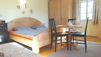 a bedroom with a bed and a table with chairs at Marta's House in Bled