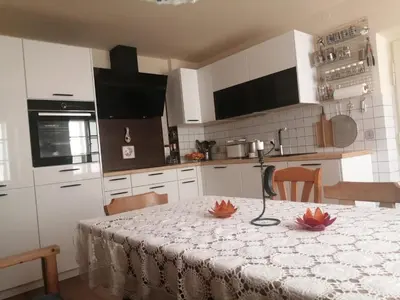 a kitchen with a table with flowers on it at Marta's House in Bled