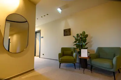 a waiting room with two chairs and a mirror at Hotel Adore in Ljubljana