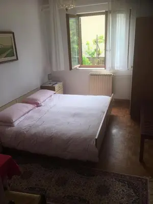 a bedroom with a large bed and a window at B&B LOKEV Lipica HostelSezana in Lokev
