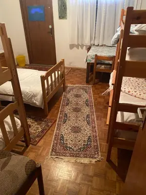 a room with two bunk beds and a rug on the floor at B&B LOKEV Lipica HostelSezana in Lokev
