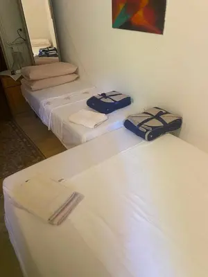 two beds in a room with towels on them at B&B LOKEV Lipica HostelSezana in Lokev