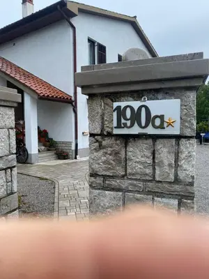 a house with a sign in front of it at B&B LOKEV Lipica HostelSezana in Lokev