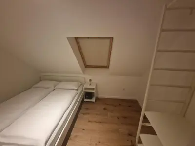 a small bedroom with a bed and a mirror at Antica Dolina in Postojna