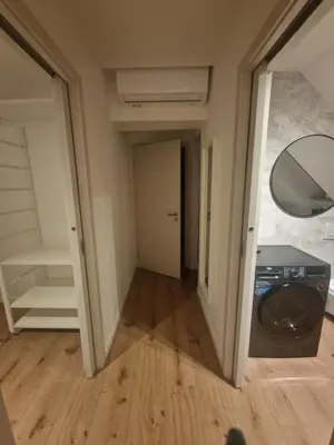 a hallway with a washer and dryer in a room at Antica Dolina in Postojna