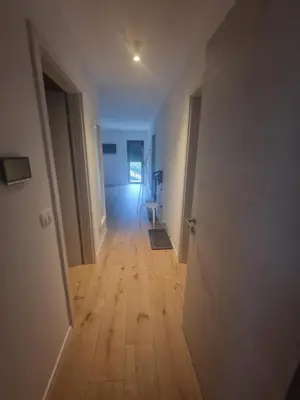 an empty room with a hallway with a wooden floor at Antica Dolina in Postojna