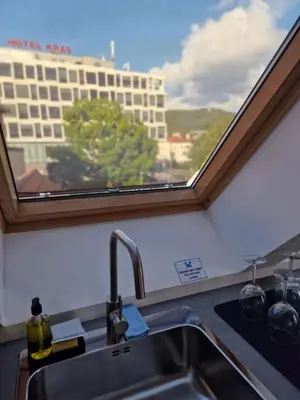 a kitchen sink with a window above a kitchen counter at Antica Dolina in Postojna