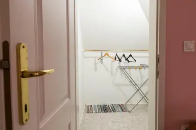 a room with a door and a closet with hangers at Vila Šiftar in Moravske Toplice