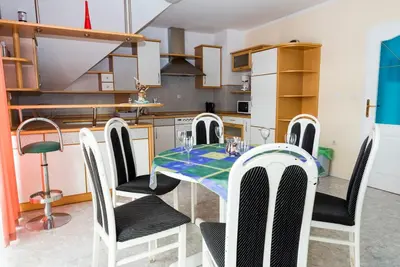 a kitchen with a dining room table and chairs at Vila Šiftar in Moravske Toplice