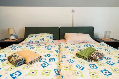 a bed with two pillows on top of it at Vila Šiftar in Moravske Toplice