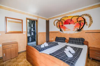a bedroom with a large bed with towels on it at Guesthouse Siva Čaplja in Videm pri Ptuju