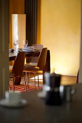 a dining room with a table with chairs and wine glasses at Room for 2 - Pri B'zjak in Kobarid