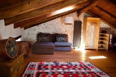 a living room with a couch and a rug at Room for 2 - Pri B'zjak in Kobarid
