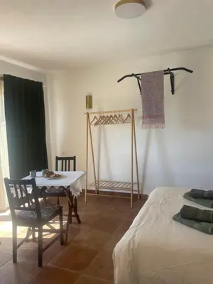 a room with a table and a chair and a bed at Vila Malina in Gaberje