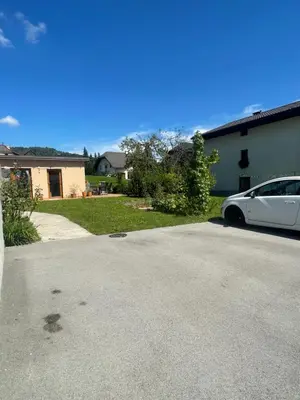 a white car parked in the driveway of a house at Vila Malina in Gaberje
