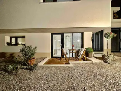 a living room with two chairs and a table at New comfortable and cute one-room apartment of 33 m2 in Ljubljana