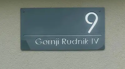 a blue sign with the number on a wall at New comfortable and cute one-room apartment of 33 m2 in Ljubljana