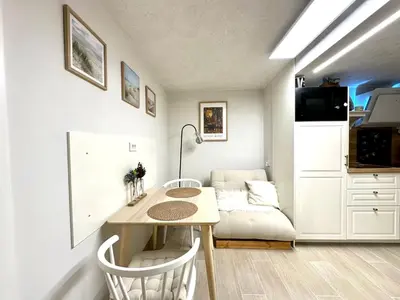 a living room with a table and a couch at New comfortable and cute one-room apartment of 33 m2 in Ljubljana