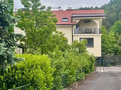 a white house with a red roof at New comfortable and cute one-room apartment of 33 m2 in Ljubljana