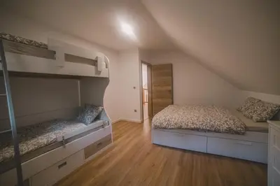 a bedroom with two bunk beds and wooden floors at Beg Residence in Rogaška Slatina