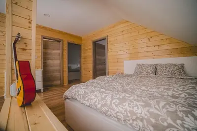 a bedroom with a bed and a guitar in it at Beg Residence in Rogaška Slatina