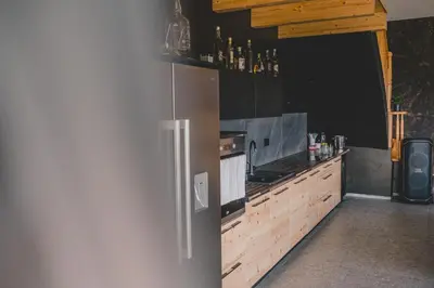 a kitchen with a refrigerator and a counter top at Beg Residence in Rogaška Slatina