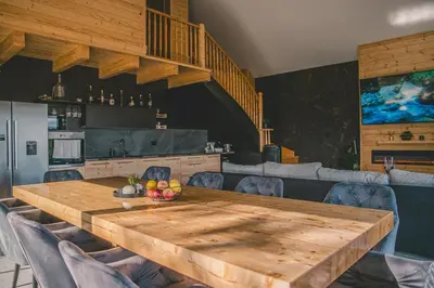 a wooden table with a bowl of fruit on it at Beg Residence in Rogaška Slatina