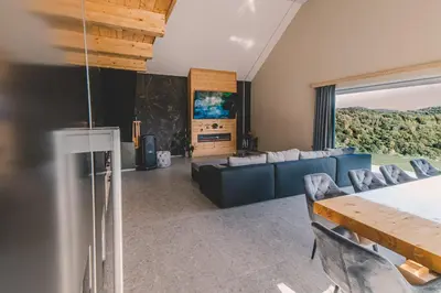 a living room with a couch and a table and chairs at Beg Residence in Rogaška Slatina