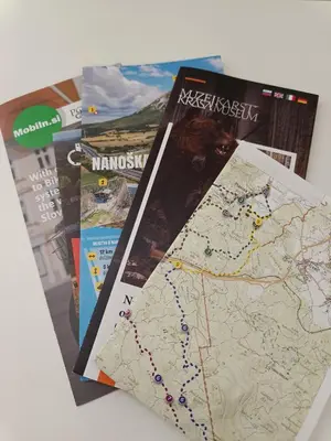 a group of books and maps on a table at SiJu loft bed in Postojna