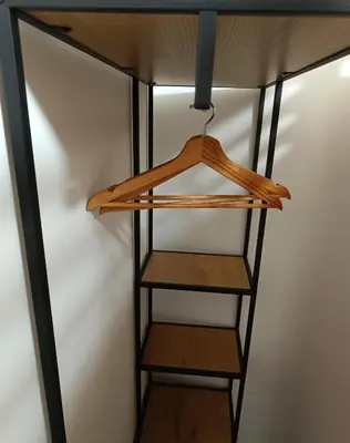 a shelf in a closet with wooden shelves at SiJu loft bed in Postojna