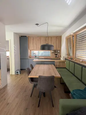 a kitchen with a table and chairs in a room at Charming house in Gozd Martuljek in Gozd Martuljek