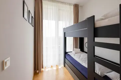 a bedroom with a bunk bed and a window at Apartma Masada in Maribor
