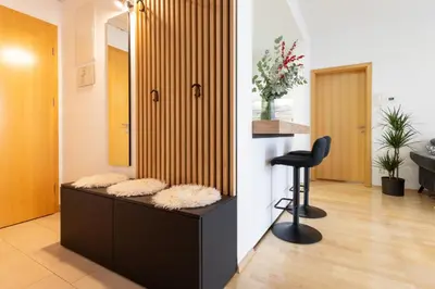 a salon with a black chair in a room at Apartma Masada in Maribor